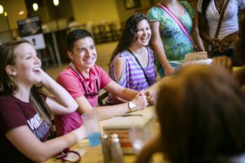 students laughing in a dining area