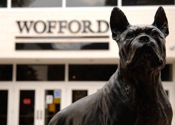 statue of a dog in front of 'wofford' building