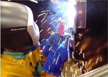 person welding with sparks flying