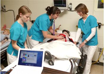 nursing students practicing on a medical dummy