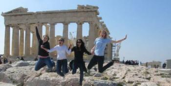 group of people jumping in front of ruins