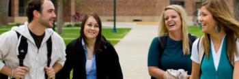 four students walking outdoors