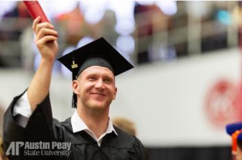 graduate holding diploma with 'AP Austin Peay State University' logo