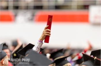 hand holding up diploma at graduation with 'AP Austin Peay State University'