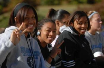 smiling students showing peace signs