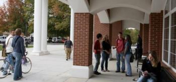 students conversing in a covered walkway