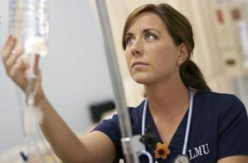 nurse adjusting IV drip in a hospital setting