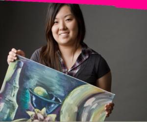 artist holding a canvas with abstract painting