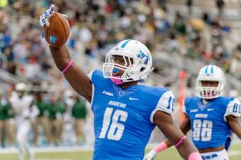 football player celebrating with the ball