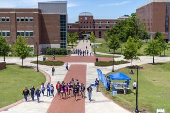 campus walkway with students and blue canopy