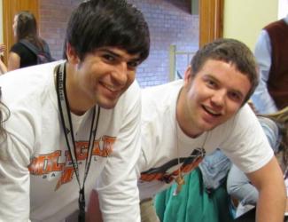 two people in white t-shirts smiling