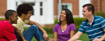 students sitting on grass and chatting