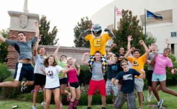 group jump with mascot and flag