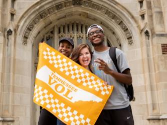 students holding a 'Tennessee VOL' banner