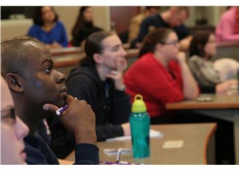 students attentively listening in a lecture hall