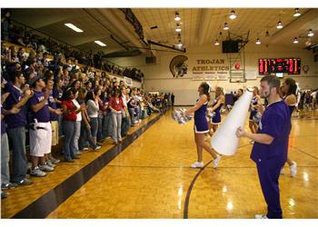 crowd cheering at a basketball game with pep band