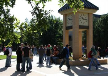 clock tower and students at campus courtyard