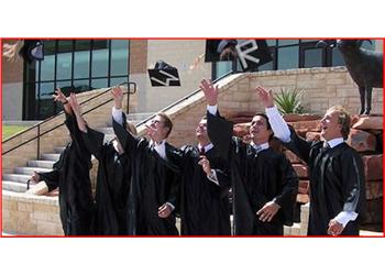 graduates throwing caps in air