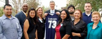 group posing with sports jersey