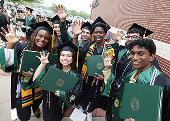 graduates in caps and gowns celebrating