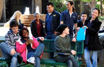 students sitting on campus bench