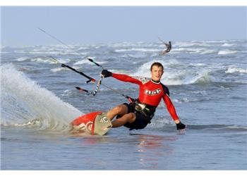 kite surfer performing a jump near the shore