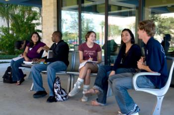 students chatting at outdoor seating