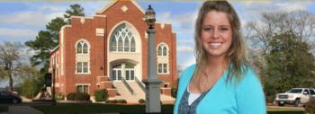 woman smiling in front of brick building