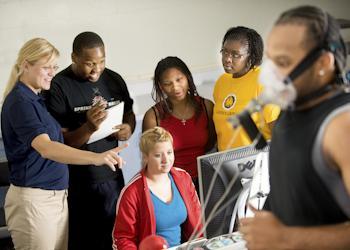 instructor and students engaged in a project