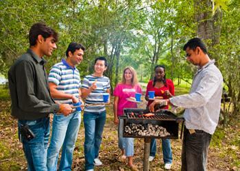 group of students enjoying a barbecue in a park area