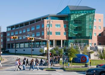 students crossing street towards UHD building