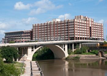 urban campus building alongside a bridge