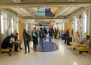 busy hallway with students and colorful art