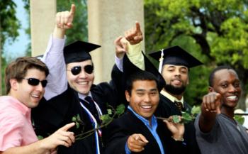 graduates with hand signs