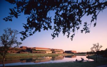 lake view of campus buildings at twilight