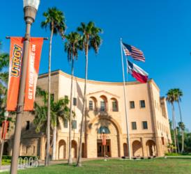 UTRGV flag, building and Texas flag