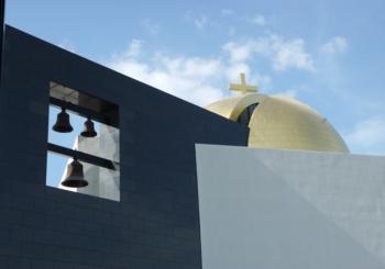 modern church architecture with cross and bells