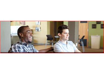 two students smiling in a classroom setting