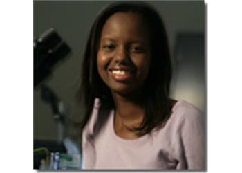 smiling female student in a lab setting