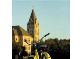 blurred bike with an academic building backdrop