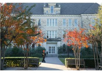 academic building with autumn trees in foreground