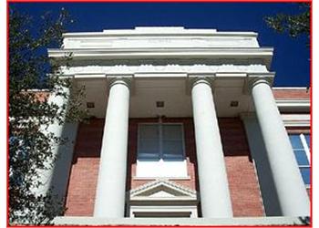 classical facade of a red brick building with columns