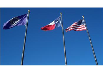 three flags against blue sky