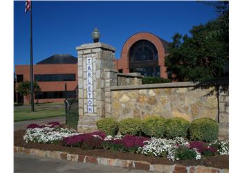 stone entrance sign surrounded by flowers