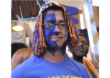 student with blue and orange wig and face paint