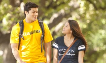 two students walking with backpacks