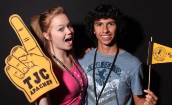 two students holding school spirit items