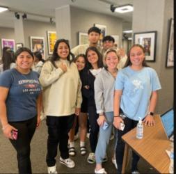 group of smiling students in a gallery