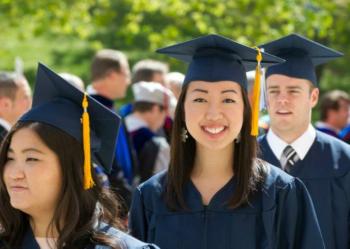 graduates in caps and gowns smiling