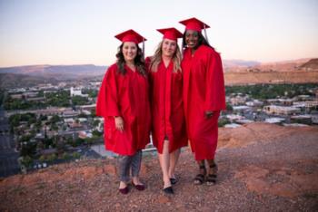 graduates overlooking cityscape